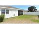 Rear view of home with screened in patio with backyard, privacy fence, and sunny skies overhead at 5089 Meadow Song Dr, Okahumpka, FL 34762