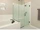 Modern bathroom featuring a soaking tub and a glass-enclosed shower with sleek, matte black fixtures at 5089 Meadow Song Dr, Okahumpka, FL 34762