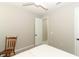 Bright bedroom featuring neutral walls, a ceiling fan, white trim, and an open doorway at 5089 Meadow Song Dr, Okahumpka, FL 34762