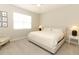 Bright bedroom featuring neutral walls and carpet, natural light, and simple elegant decor at 5089 Meadow Song Dr, Okahumpka, FL 34762