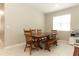 Bright dining area features a classic table with bench seating and modern tile floors at 5089 Meadow Song Dr, Okahumpka, FL 34762