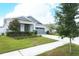 Beautiful home with well maintained lawn, landscaping, gray tones and complimentary stone accents at 5089 Meadow Song Dr, Okahumpka, FL 34762