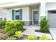 Inviting front porch with colorful shutters and stone accents for added curb appeal at 5089 Meadow Song Dr, Okahumpka, FL 34762