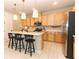 Modern kitchen with stainless steel appliances, white countertops, and a central island with breakfast bar seating at 5089 Meadow Song Dr, Okahumpka, FL 34762