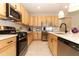 Bright kitchen with stainless steel appliances and white countertops and ample counter space at 5089 Meadow Song Dr, Okahumpka, FL 34762