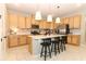 Modern kitchen with stainless steel appliances, white countertops, a central island with breakfast bar seating at 5089 Meadow Song Dr, Okahumpka, FL 34762