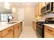 Bright kitchen with stainless steel appliances and white countertops with a view to the outdoor patio at 5089 Meadow Song Dr, Okahumpka, FL 34762
