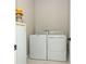 Efficient laundry room equipped with a washer, dryer, and ample space for storage at 5089 Meadow Song Dr, Okahumpka, FL 34762