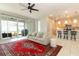 Bright, open living space featuring a modern kitchen and comfortable lounge area with outdoor patio access at 5089 Meadow Song Dr, Okahumpka, FL 34762