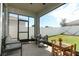This screened in patio offers seating, table with flowers and opens to fenced backyard with sunny skies at 5089 Meadow Song Dr, Okahumpka, FL 34762
