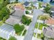 A high-level aerial view of the home, surrounded by trees and ponds in a residential community at 516 Brett Ct, Orlando, FL 32828
