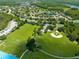 Aerial view of RV parking, baseball and soccer fields, and tennis courts, surrounded by mature trees and lakes at 516 Brett Ct, Orlando, FL 32828