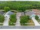 A higher aerial view of the home, showing proximity to ponds and green wooded areas at 516 Brett Ct, Orlando, FL 32828