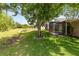 Beautiful backyard features lush lawn and view of screened patio at 516 Brett Ct, Orlando, FL 32828