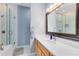 Updated bathroom features a glass enclosed shower, modern lighting and quartz countertops at 516 Brett Ct, Orlando, FL 32828