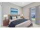 Beautifully staged bedroom with stylish furniture, soft lighting, and serene ocean view artwork at 516 Brett Ct, Orlando, FL 32828