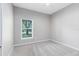 Neutral bedroom with ceiling fan and natural light from a window with tree view at 516 Brett Ct, Orlando, FL 32828