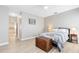 Neutral bedroom with wood-look flooring, ample natural light and wood accent chest at 516 Brett Ct, Orlando, FL 32828