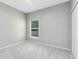 Bright bedroom features neutral walls, plush carpeting and a window for natural light at 516 Brett Ct, Orlando, FL 32828