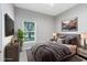 Staged primary bedroom with modern decor, plush bedding and ample natural light at 516 Brett Ct, Orlando, FL 32828