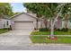 Charming single-Gathering home featuring a well-maintained lawn, mature trees, and inviting curb appeal at 516 Brett Ct, Orlando, FL 32828