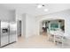 Eat-in kitchen has a large stainless steel refrigerator, white cabinets, and neutral tile floors at 516 Brett Ct, Orlando, FL 32828