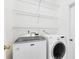 Functional laundry room with modern appliances and wire shelving for organized storage at 516 Brett Ct, Orlando, FL 32828