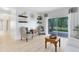 Spacious living room boasts light wood floors, decor shelves and a screened-in porch view at 516 Brett Ct, Orlando, FL 32828