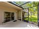 Screened-in patio offering views of the lush backyard and mature trees at 516 Brett Ct, Orlando, FL 32828