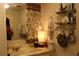 Well-lit bathroom featuring a vanity with floral curtains, a decorative lamp, and a framed mirror at 518 W Plantation Blvd, Lake Mary, FL 32746