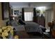 Comfortable bedroom with a patterned comforter, dark wood dresser, and bright window at 518 W Plantation Blvd, Lake Mary, FL 32746