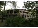 Modern two-story building featuring large windows, surrounded by lush green landscaping and mature trees at 518 W Plantation Blvd, Lake Mary, FL 32746