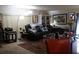 Cozy living room featuring a black leather sofa, decorative pillows, and a large patterned rug at 518 W Plantation Blvd, Lake Mary, FL 32746