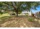 The backyard features mature trees providing ample shade at 520 Stonewall Ave, Haines City, FL 33844