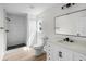 Bathroom features modern design with a walk-in shower, white vanity, and updated fixtures at 520 Stonewall Ave, Haines City, FL 33844