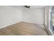 Bright, empty bedroom with wood floors, arched window, and plenty of natural light at 520 Stonewall Ave, Haines City, FL 33844