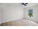 This spacious bedroom features a large window and stylish wood-look flooring at 520 Stonewall Ave, Haines City, FL 33844