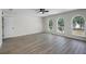 Bedroom featuring light wood floors, ceiling fan, and a window with neighborhood views at 520 Stonewall Ave, Haines City, FL 33844