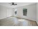 Spacious bedroom with two windows, closet and light, wood-look flooring at 520 Stonewall Ave, Haines City, FL 33844