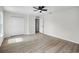 Spacious bedroom featuring two windows, wood look floors, ceiling fan and double closet at 520 Stonewall Ave, Haines City, FL 33844