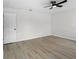 A bright bedroom features light-colored walls, wood-look floors, and a modern ceiling fan at 520 Stonewall Ave, Haines City, FL 33844