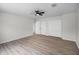 Minimalist bedroom with wood-look flooring and ample closet space, creating a serene environment at 520 Stonewall Ave, Haines City, FL 33844