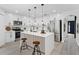 Modern kitchen featuring white cabinets, stainless steel appliances, and an island with bar seating at 520 Stonewall Ave, Haines City, FL 33844