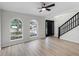 Bright, airy living space with wood floors, arched windows, and a staircase leading to the upper level at 520 Stonewall Ave, Haines City, FL 33844