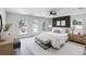 Elegant primary bedroom with a modern accent wall, arched windows, and a cozy seating area at 520 Stonewall Ave, Haines City, FL 33844
