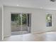 View of the outdoor patio through sliding glass doors in a well-lit room at 520 Stonewall Ave, Haines City, FL 33844