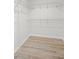 Empty walk-in closet featuring metal shelving and wood look floors at 520 Stonewall Ave, Haines City, FL 33844