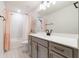 Modern bathroom featuring a gray vanity, quartz countertop, and decorative shower curtain at 5226 Northern Flicker Dr, St Cloud, FL 34771