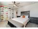 Bedroom with a grey upholstered headboard and decorative shoe display at 5226 Northern Flicker Dr, St Cloud, FL 34771