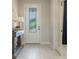Bright foyer with decorative glass front door and wood look tile flooring at 5226 Northern Flicker Dr, St Cloud, FL 34771